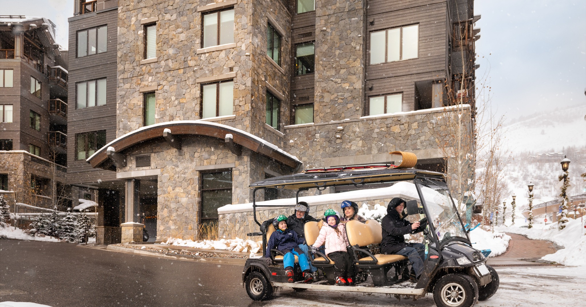 the lion vail concierge service giving a family a ride on a golf cart